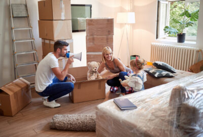 Young family playing in new apartment.